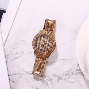 Detailed top view of natural bamboo texture quartz watch on marble surface background