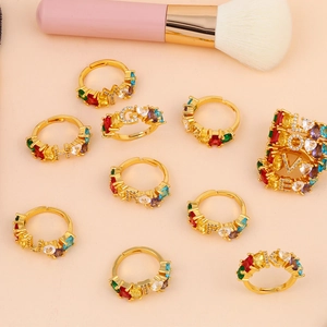 Golden adjustable rings with colorful crystals and sparkling diamond-set letters