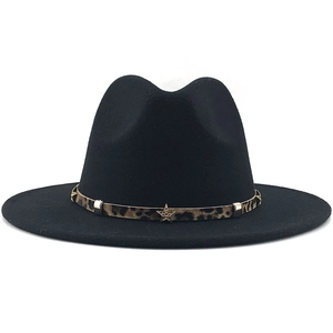 Close-up of black wool fedora featuring leopard print band and golden star emblem