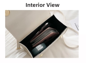 Interior view of cream crocodile-effect leather bag showing spacious black-lined compartment