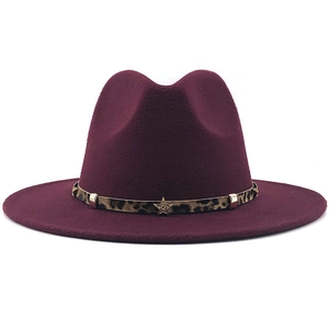 Detail of wine red fedora hat with leopard print band and gold star metal studs