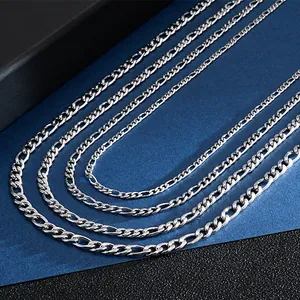 Detailed macro view of silver stainless steel Figaro 3:1 NK link chain necklaces