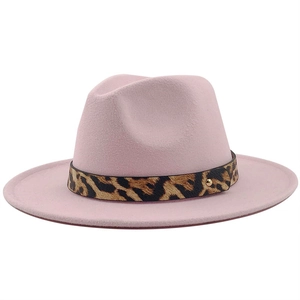 Detailed macro view of pink wool fedora featuring leopard print band and golden metal rivet