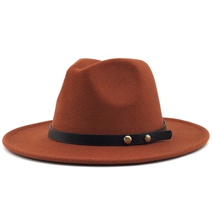 Detail of caramel wool fedora with black leather band and golden metallic rivets