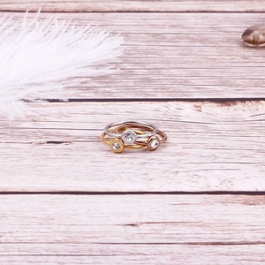 Three-piece set of minimalist thin band rings in gold, silver, and rose gold with zircons