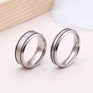 Matching silver titanium steel rings for couples with brushed finish and black grooves
