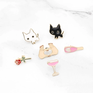 Set of 6 cute cartoon enamel pins featuring cats, roses, and wine glasses on marble