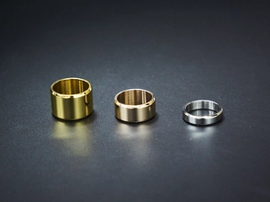 Minimalist stackable titanium rings set in gold, rose gold and silver colors with varying widths