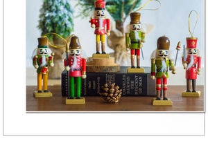 Detailed set of six hand-painted wooden nutcracker soldiers with holiday props