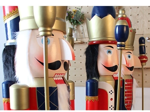 Detailed close-up of 180cm wooden nutcracker soldiers standing against a pegboard wall