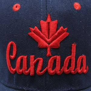 Navy blue cotton baseball cap featuring red maple leaf and Canada script embroidery