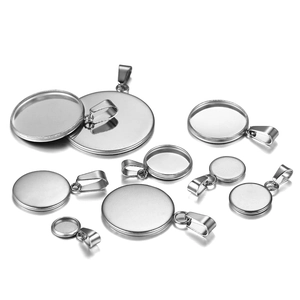 Macro view of assorted silver metal pendant trays and bails for DIY jewelry making