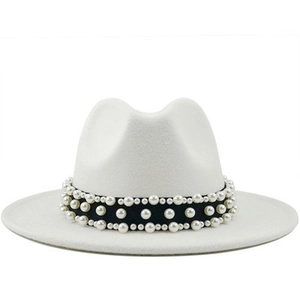 Macro detail of white wool fedora hat featuring black satin band with pearl accents