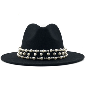 Close-up of luxury black wool fedora featuring three rows of elegant pearl band decoration