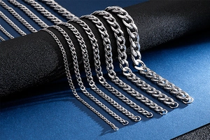 Detailed comparison of various thicknesses of silver Cuban link chains on a black surface