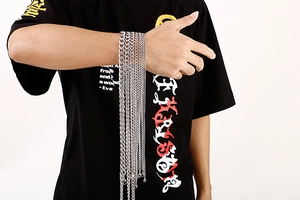 Close-up of various silver stainless steel NK chains on model arm for hiphop style