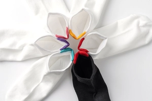 Radial arrangement of minimalist cotton socks with colorful heel tabs in various colors