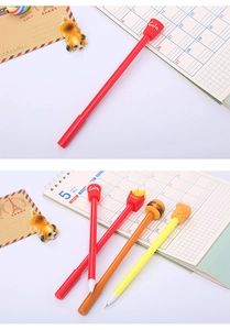 Close-up of creative fast food shaped pens including cola and fries designs on a desk
