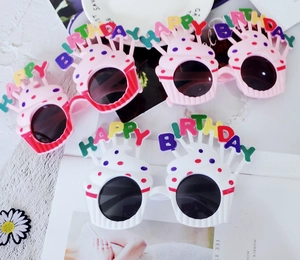 Close-up of pink and white cupcake birthday party sunglasses with Happy Birthday text