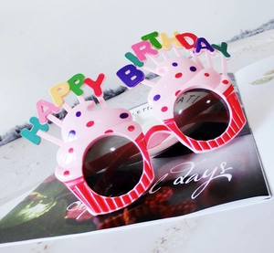 Detailed view of pink and red cupcake birthday party glasses with happy birthday letters