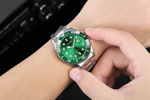 Detailed close-up of a men's quartz watch with a green dial and rotating dive bezel