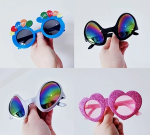 Detailed view of fun party sunglasses including blue balloon and pink glitter heart styles