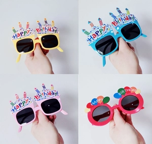 Close-up of funny daisy sunglasses in four colors for birthday party photo props