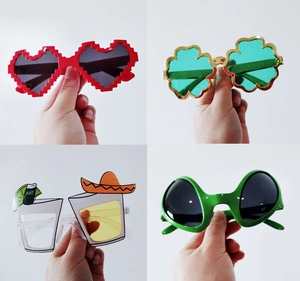 Four fun novelty party glasses featuring daisy, heart and clover designs for photo props