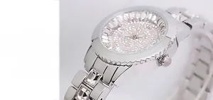 Detail showing crystal-encrusted silver watch dial and studded links with quartz movement