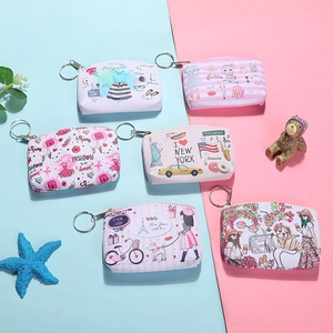 Detailed close-up of colorful printed canvas coin purses with a sturdy metal keychain loop