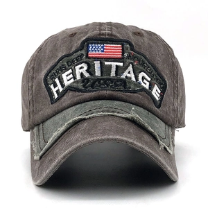 Detail of vintage baseball cap with heritage embroidery and distressed brim texture