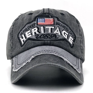 Detail of vintage grey baseball cap featuring Heritage USA embroidery and distressed brim