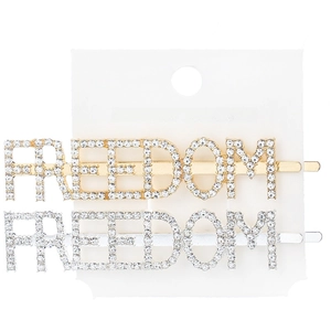 Close-up of gold and silver plated FREEDOM rhinestone hair clips on display card