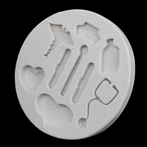 White silicone mold with medical shapes like stethoscope and nurse hat for fondant cakes