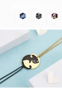 Détail macro des pendentifs puzzle chat en acier titane doré et noir poli brillant