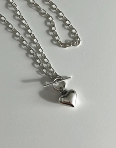 Macro shot of silver S925 heart pendant necklace with stylish OT toggle clasp