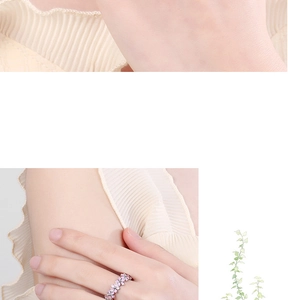 Detail of pink floral enamel open ring with leaf design on a female model's hand