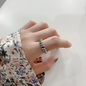 Detail of 925 sterling silver twist ring with vintage black finish on hand