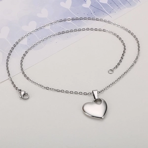 Elegant minimalist silver heart pendant necklace on a decorative background