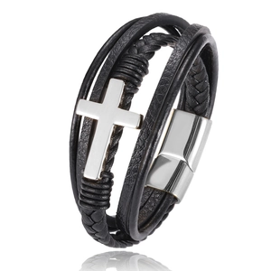Detail of black leather braided bracelet with silver cross and magnetic clasp