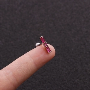 Macro detail of silver stud earring with magenta stones and ball screw back design