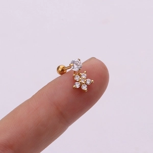 Macro detail of a small flower dangle earring with zircon stones and a screw ball back