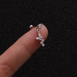 Close-up of butterfly zircon drop earring with screw back ball held by a finger