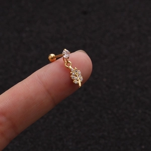 Macro shot of gold leaf pendant earring with cubic zirconia on a screw flat back stud
