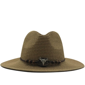 Brown woven cowboy straw hat with silver bull head metal decor and beaded band detail
