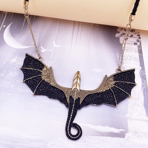 Gothic dragon pendant necklace in antique gold and black on mystical art background