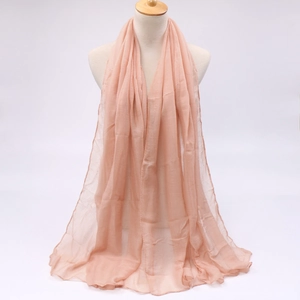 Detailed view of light pink voile scarf with delicate overlock edges on a mannequin