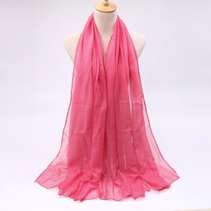 Detail of hot pink lightweight sheer scarf on mannequin with soft texture and drape