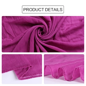 Detail of magenta voile scarf showing breathable crinkle texture and neat hemmed edges