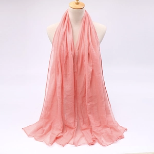 Detail view of light pink candy-colored voile scarf with soft drape on a mannequin